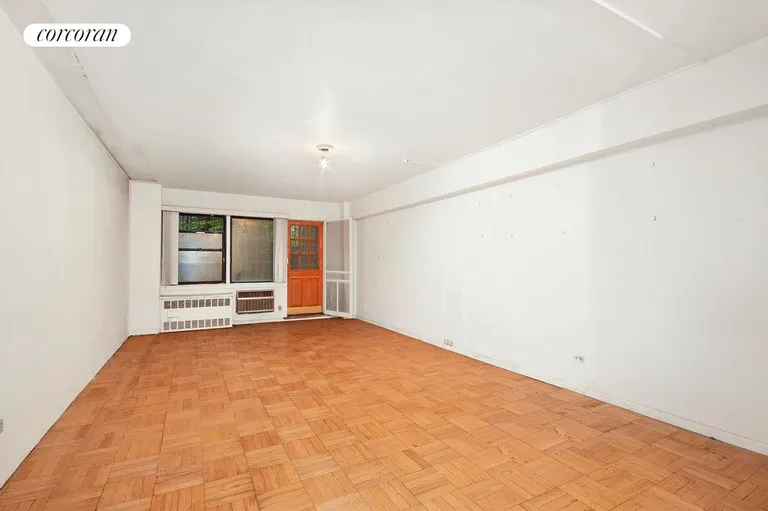 New York City Real Estate | View 205 East 77th Street, 1E | Living Room with Garden Access | View 2
