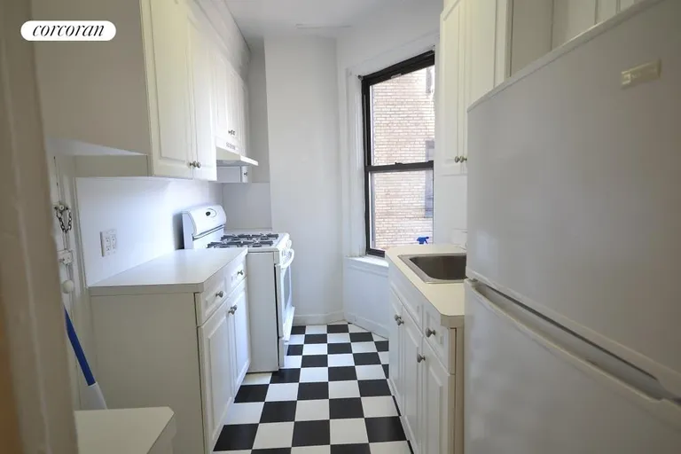 New York City Real Estate | View 201 West 77th Street, 2A | Black and white kitchen | View 5