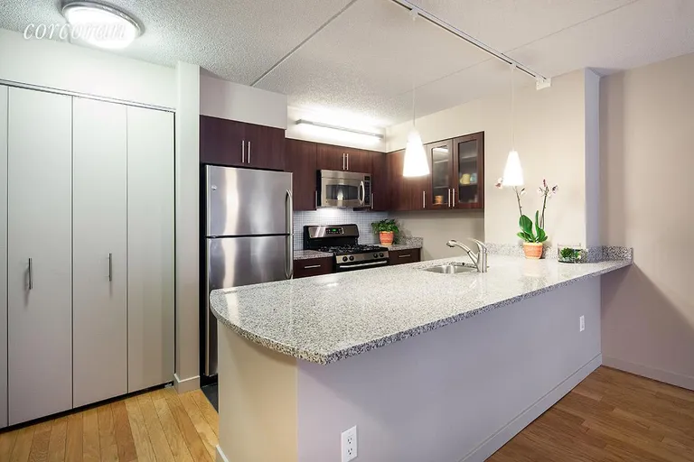 New York City Real Estate | View 555 West 23rd Street, S7M | Open kitchen w/ dishwasher & granite counters | View 2