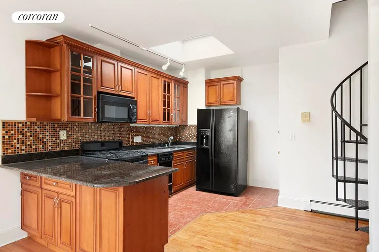 New York City Real Estate | View 559 Warren Street, 4R | Kitchen with Spiral Staircase Leading to the Roof | View 4