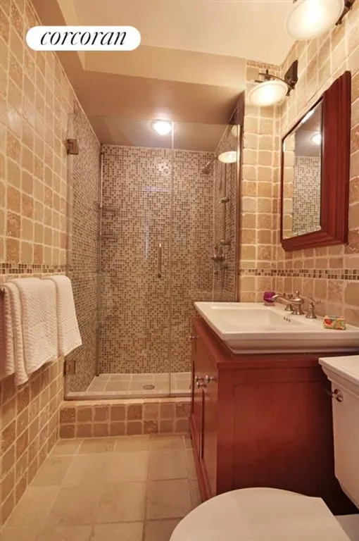New York City Real Estate | View 301 East 69th Street, 2L | Master Bathroom with honed stone tiles | View 6
