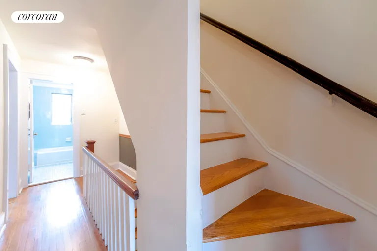 New York City Real Estate | View 75-39 Kessel Street | Staircase leading to bedroom floors | View 6