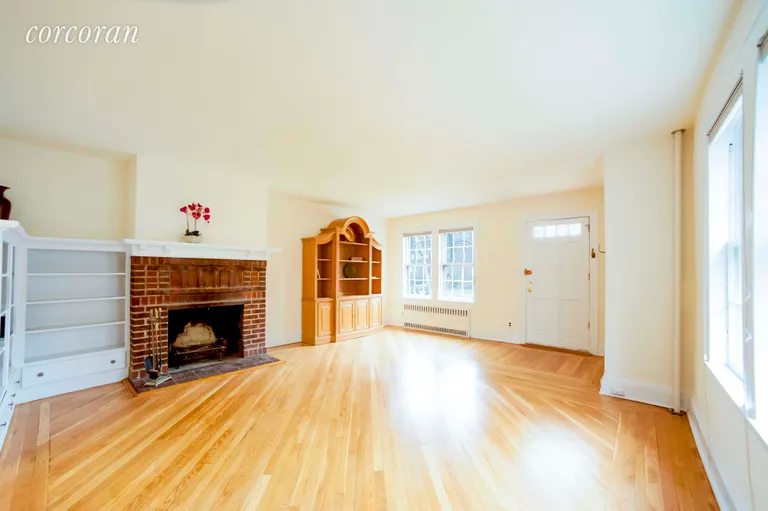 New York City Real Estate | View 75-39 Kessel Street | Large living area w/WBF & custom library shelving | View 2