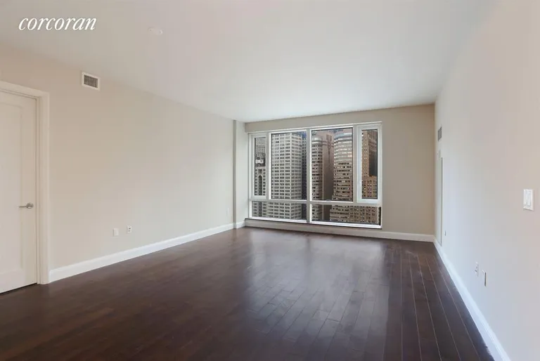 New York City Real Estate | View 70 Little West Street, 26F | Spacious living room with gorgeous city views | View 2