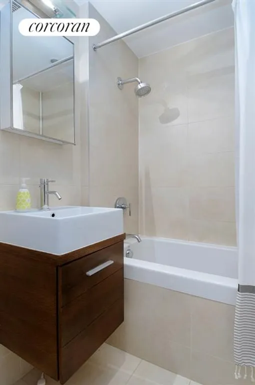 New York City Real Estate | View 133 Water Street, 11D | Bathroom w/ deep soaking tub and floating vanity | View 4