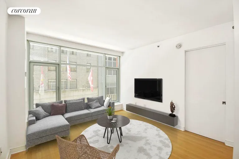 New York City Real Estate | View 5 East 44th Street, 5A |  living room with wall of windows | View 3