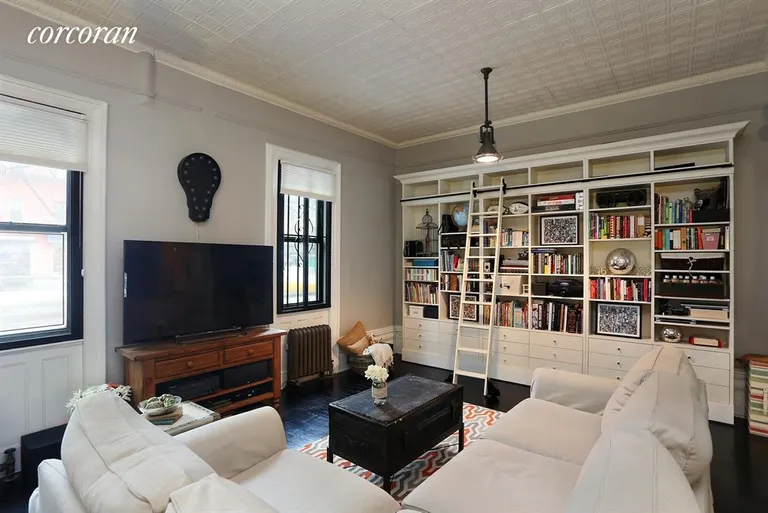 New York City Real Estate | View 193 Second Avenue, 1F | Bookshelves with library ladder. | View 2