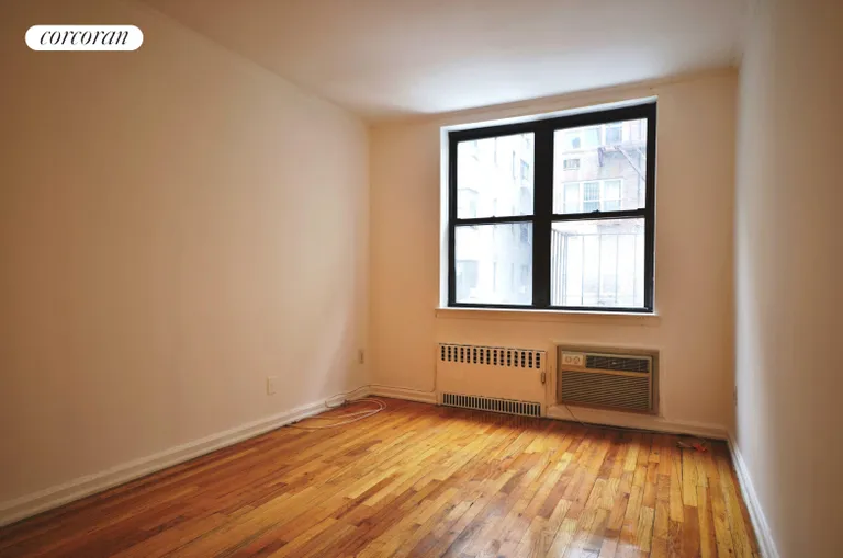 New York City Real Estate | View 222 East 75th Street, 2E | Brightly lit living area with through-wall A/C. | View 5