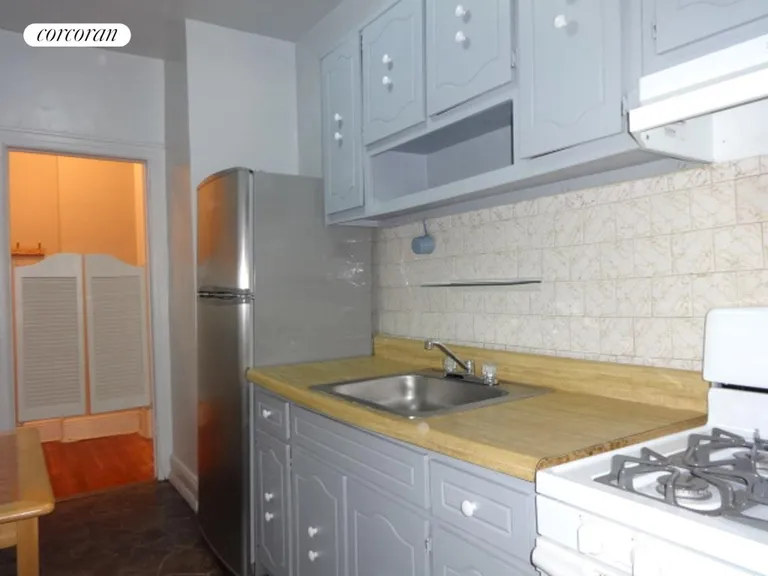 New York City Real Estate | View 1506 Overing Street, 7B | Kitchen with appliances and cabinetry | View 8