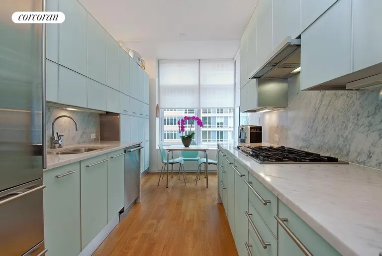 New York City Real Estate | View 310 East 53rd Street, 24B | Large, windowed Eat-in-Kitchen overlooks balcony | View 3