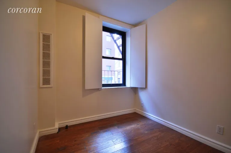 New York City Real Estate | View 202 Thompson Street, 4 | Sunny bedroom with covered radiator. | View 3