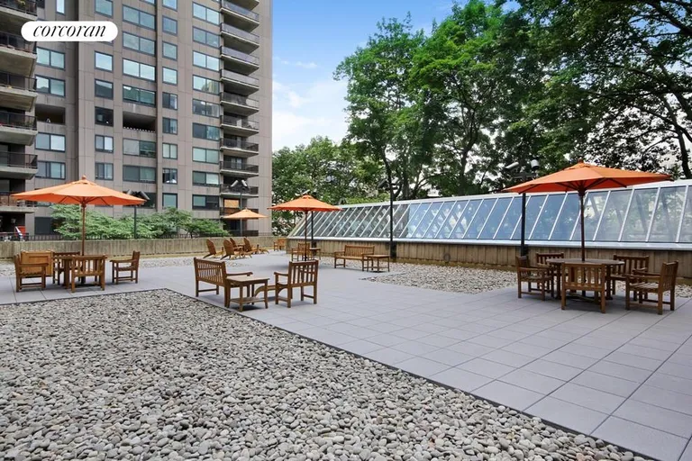 New York City Real Estate | View 531 Main Street, 1802 | sun deck surrounded by trees, gardens, water views | View 9