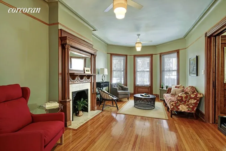 New York City Real Estate | View 329 Westminster Road | Decorative fireplace, bay front + pocket doors | View 3