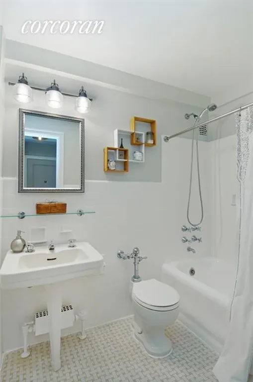 New York City Real Estate | View 225 East 73rd Street, 1A | Bath with cast iron bath and white tiled walls | View 4