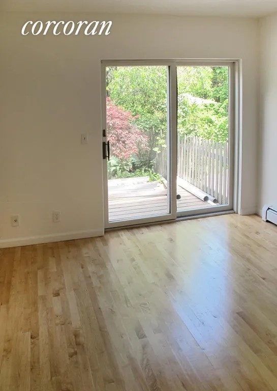 New York City Real Estate | View 213 Wyckoff Street, 1 | Bedroom with doors leading to deck | View 4