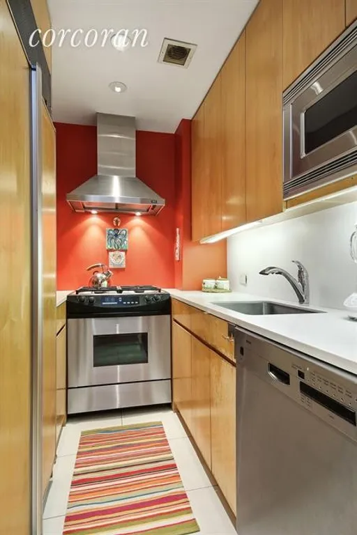 New York City Real Estate | View 30 East 62nd Street, 9H | Custom Kitchen with stainless appliances | View 4