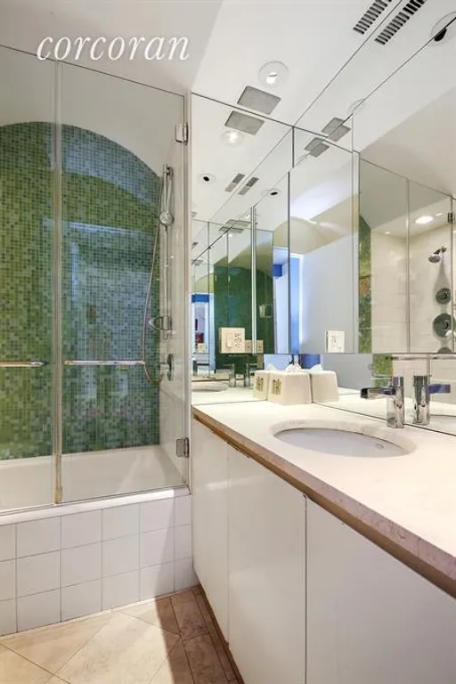 New York City Real Estate | View 30 East 62nd Street, 9H | Bathroom with stone and tile finishes | View 6