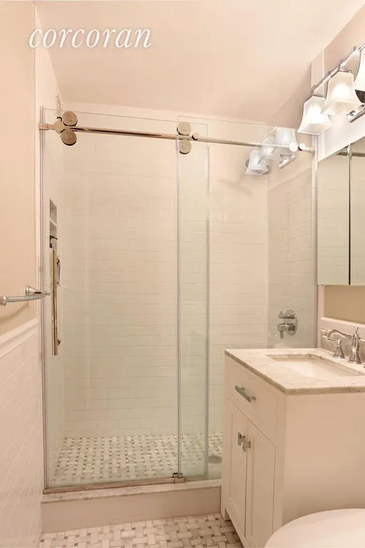 New York City Real Estate | View 309 East 87th Street, 3MN | En-suite bath with basket weave Carrera tiling  | View 6