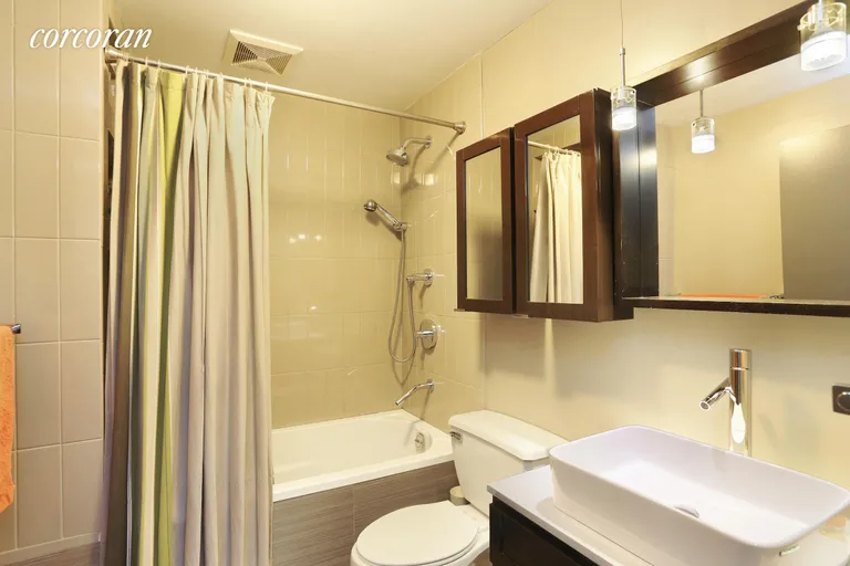 New York City Real Estate | View 176 Broadway, 12F | Updated bathroom with a deep soaking tub | View 3