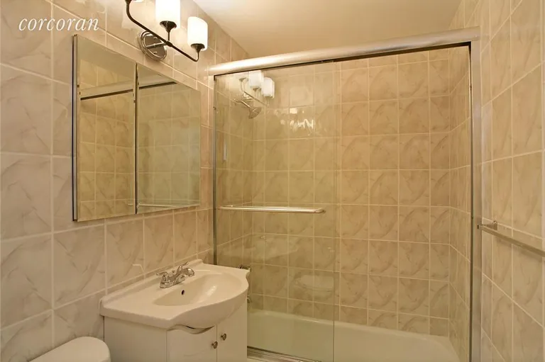 New York City Real Estate | View 220 East 60th Street, 4E | Ceramic Tiled Bath with Glass Enclosed Shower | View 4