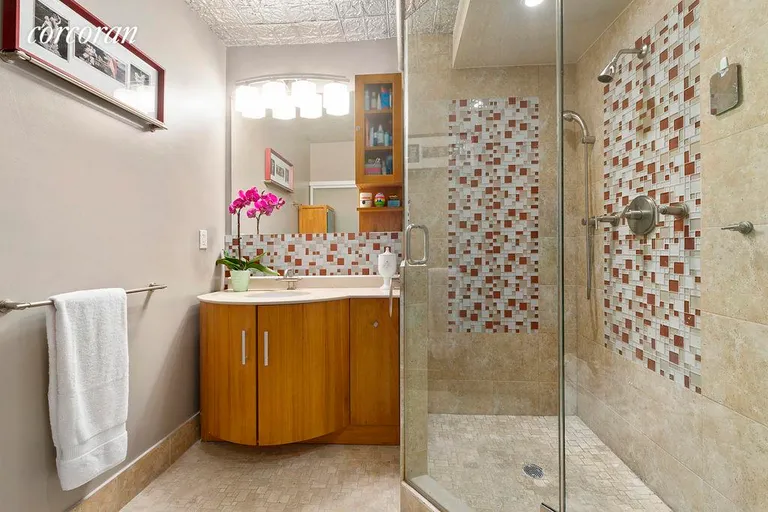 New York City Real Estate | View 131 West 28th Street, 4D | Bright, custom-tiled baths! | View 6