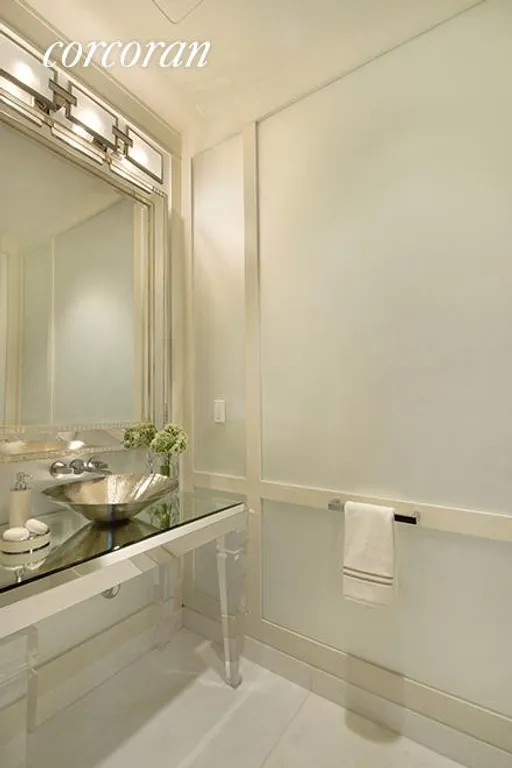 New York City Real Estate | View 20 West 53rd Street, 38A | Powder room with frosted, mirrored glass-panels | View 7