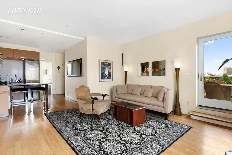 New York City Real Estate | View 330 East 119th Street, 7A | Living room with direct access to the main terrace | View 3