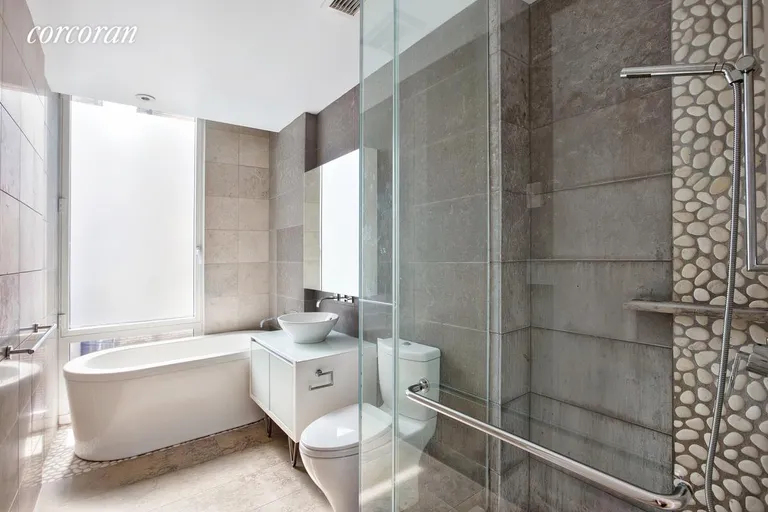 New York City Real Estate | View 247 West 46th Street, 1505 | Windowed bathroom with free standing tub & shower | View 6
