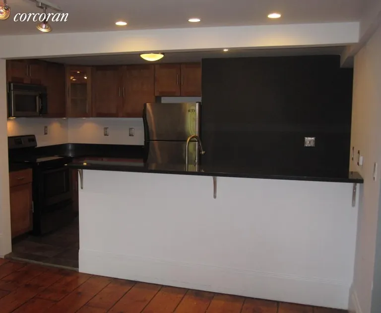New York City Real Estate | View 160 Hoyt Street, 1 | Kitchen with breakfast bar from the Living Room | View 6