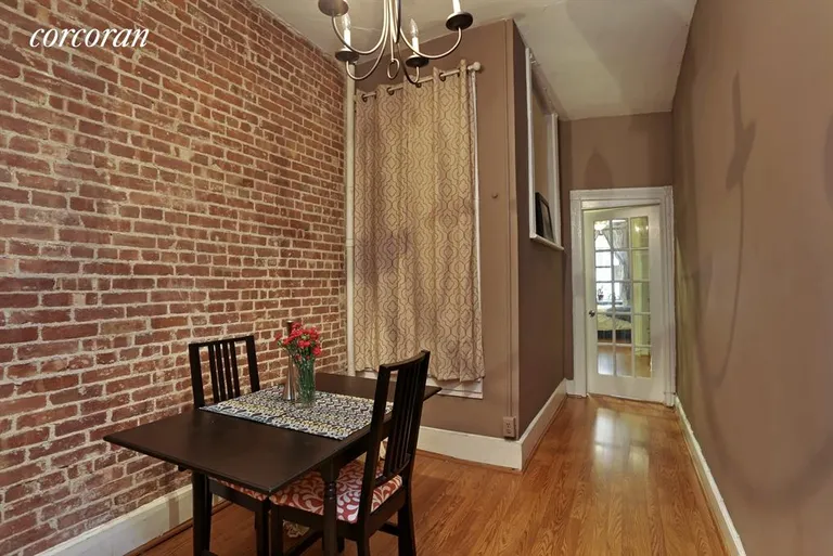 New York City Real Estate | View 348 West 48th Street, 1W | Windowed dining room with exposed brick. | View 2