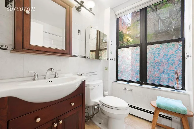 New York City Real Estate | View 317 West 95th Street, 1D | Renovated bathroom with window and large tub | View 4