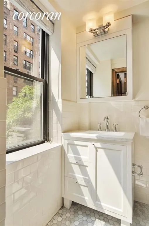 New York City Real Estate | View 235 East 73rd Street, 5AG | Windowed bath with subway tile and custom vanity | View 16