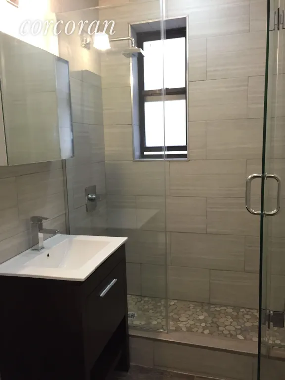 New York City Real Estate | View 48-54 West 138th Street, 5M | pebbled shower, rainforest shower, mirrors cabniet | View 3