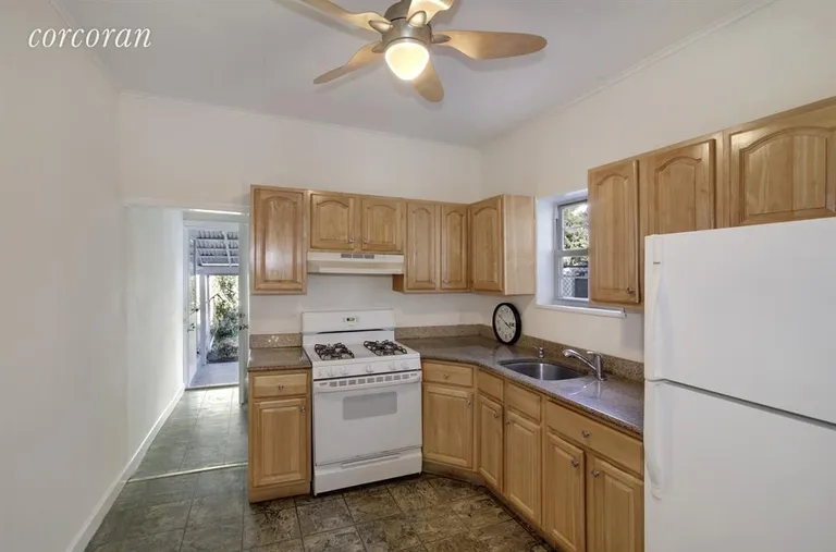 New York City Real Estate | View 157A 14th Street | 1st floor kitchen with a door to the garden | View 4