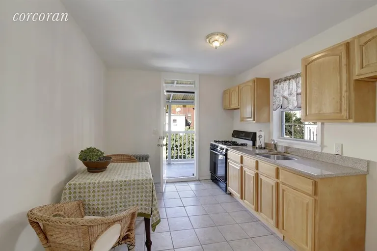 New York City Real Estate | View 157A 14th Street | 2nd floor kitchen with a door to the balcony | View 7