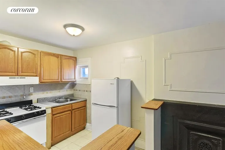 New York City Real Estate | View 58 Madison Street | Upper kitchen with decorative fireplace | View 7