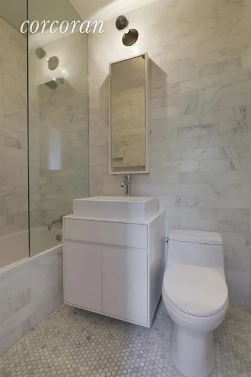 New York City Real Estate | View 164 Sterling Place, 4C | White marble bathroom with glass shower wall | View 7