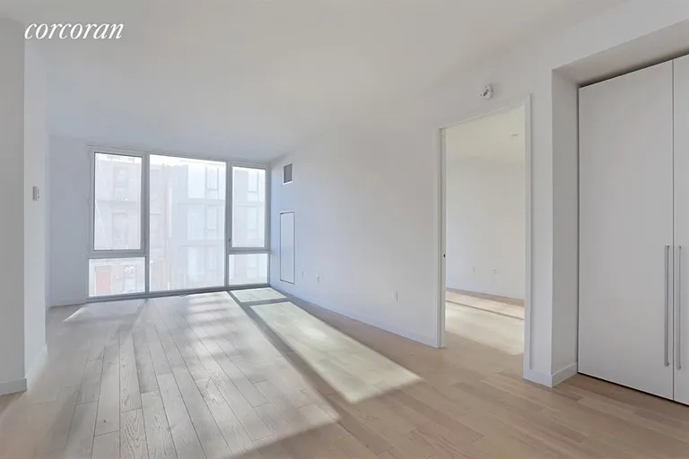 New York City Real Estate | View 540 West 49th Street, 301S | Spacious light-filled living room. | View 2