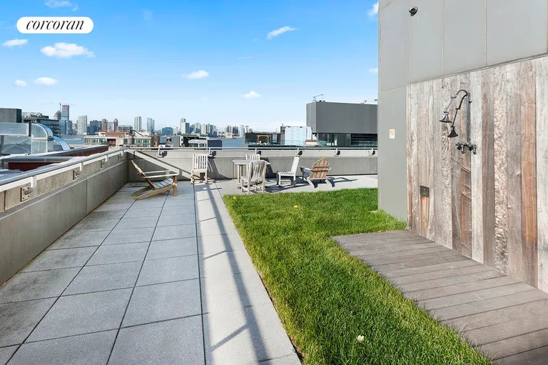 New York City Real Estate | View 255 Hudson Street, PHE | Common roof deck with shower and views | View 9