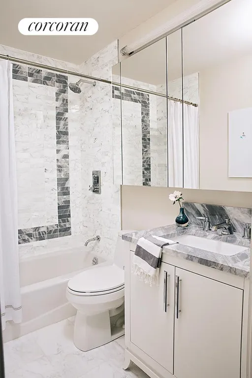 New York City Real Estate | View 200 East 94th Street, 1516 | Bathroom with Caldia Marble | View 3