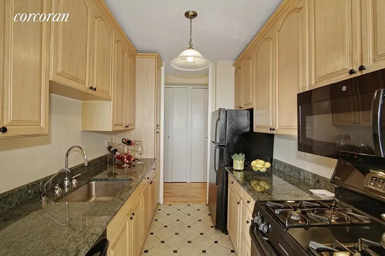 New York City Real Estate | View 115 East 87th Street, 39E | Pass-thru Kitchen with granite and wood cabinetry | View 5