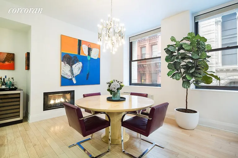 New York City Real Estate | View 150 Nassau Street, 10A | Dining area with cozy fireplace | View 2
