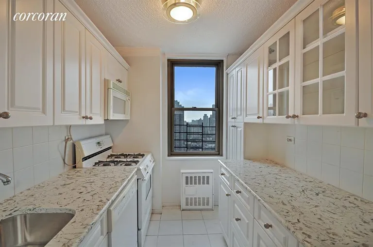 New York City Real Estate | View 301 East 79th Street, 30B | Windowed Kitchen Granite counters stainless fridge | View 3