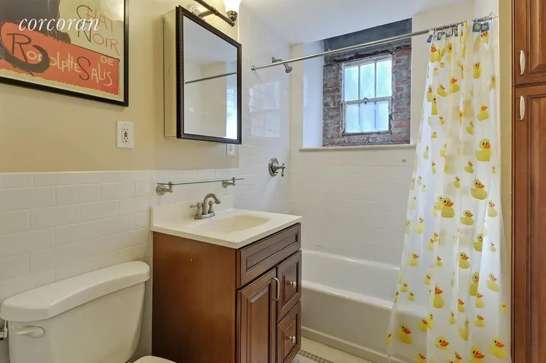 New York City Real Estate | View 186 Prospect Park West, A | Bathroom with white subway tile & exposed brick | View 7