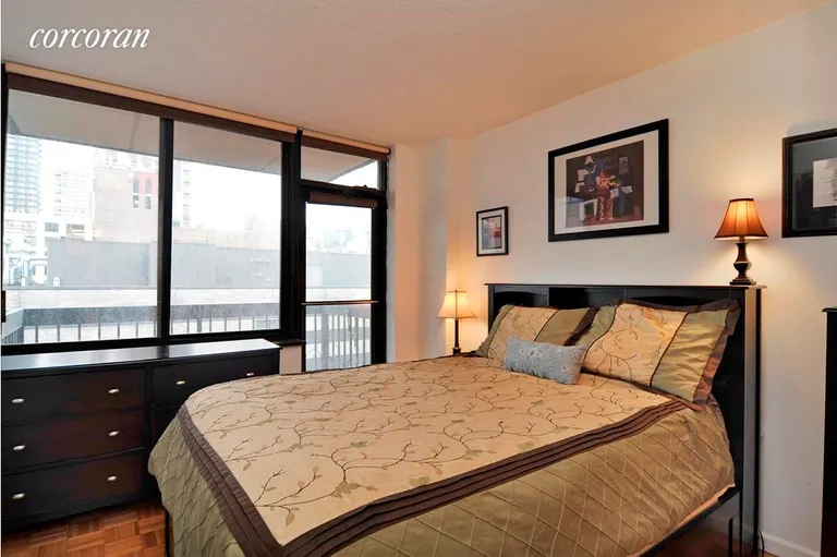 New York City Real Estate | View 403 East 62Nd Street, 8D | South-facing bedroom with access to balcony | View 3