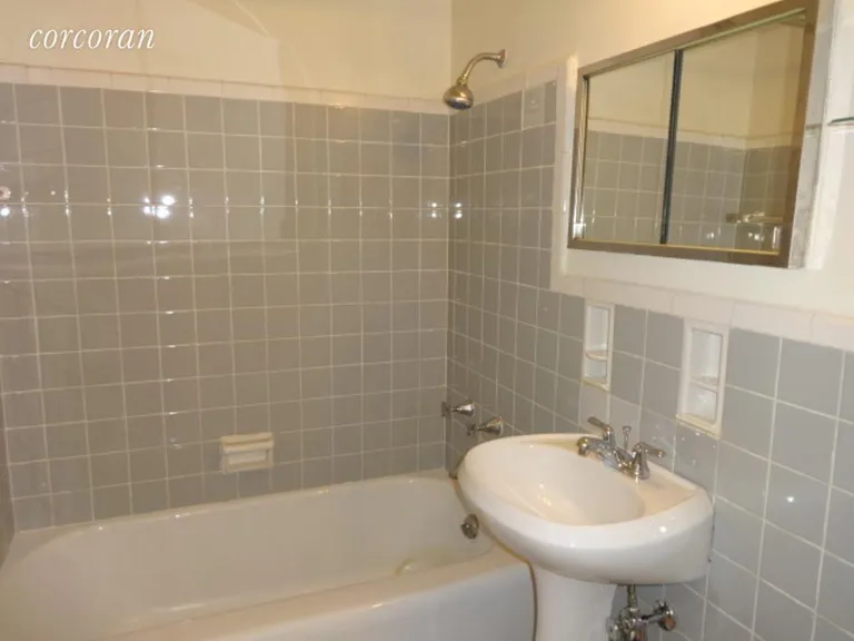 New York City Real Estate | View 191 Willoughby Street, 11F | Grey Tiled Bath with Tub | View 10