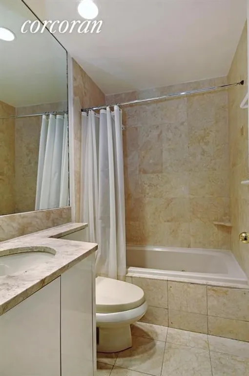 New York City Real Estate | View 100 United Nations Plaza, 6F | Marble Bathroom with Jacuzzi Tub | View 4