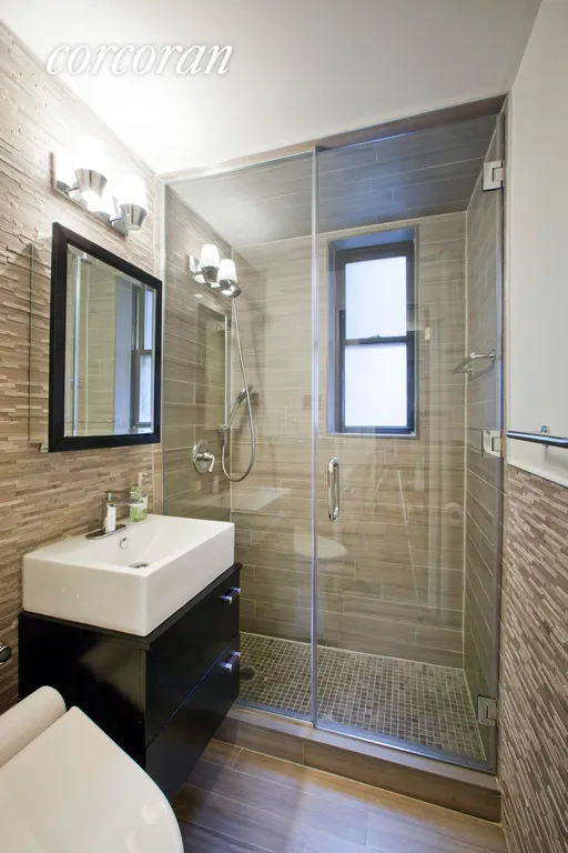 New York City Real Estate | View 208 East 70th Street, 1AB | Emperador Marble with Glass Enclosed Shower. | View 3