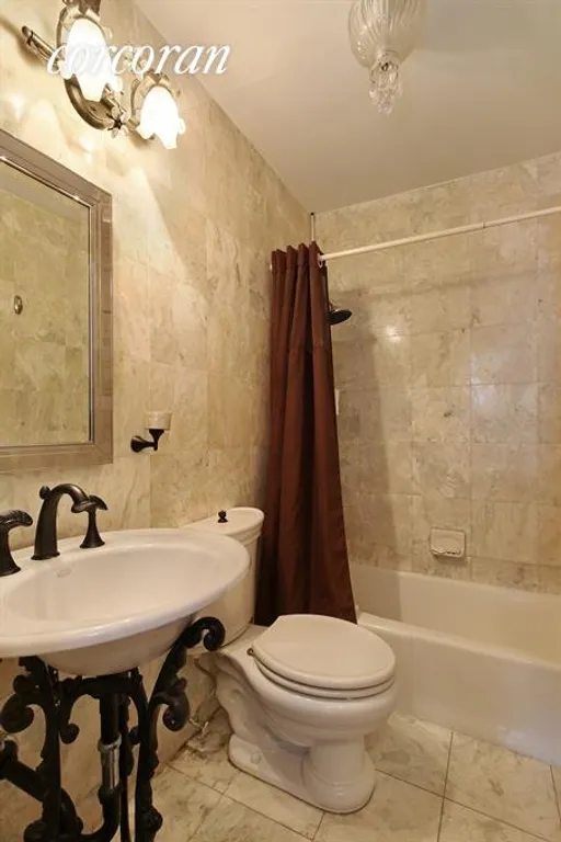 New York City Real Estate | View 220 East 65th Street, 5D | Renovated tiled bathroom  | View 4