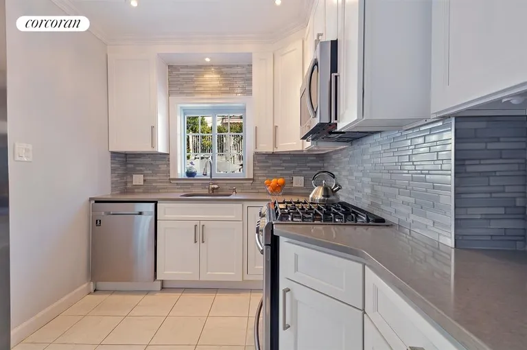 New York City Real Estate | View 517 73rd Street | Renovated Kitchen Leading to Rear Yard | View 6